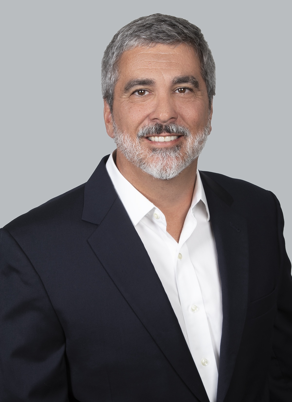 A professional headshot of Chris Neyrey