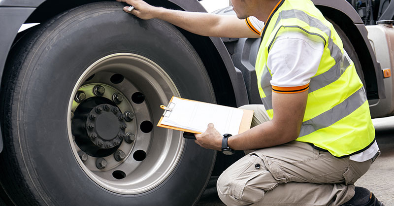 Male looking at truck tire