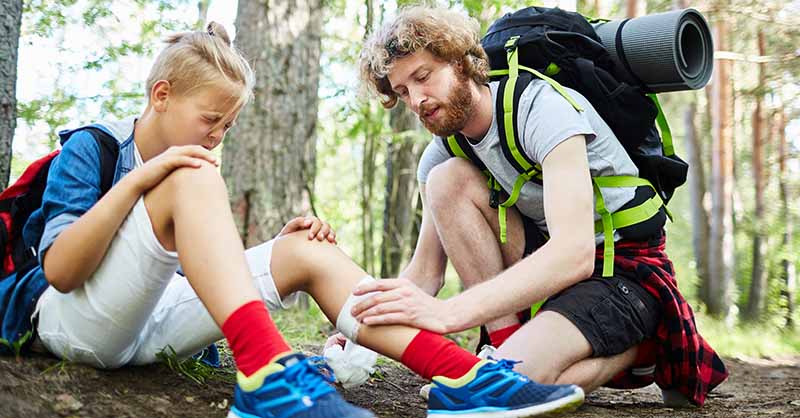 Camp nurse helping hurt camper