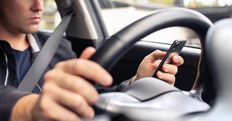 Man texting and driving at work