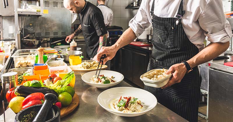 Chef safely preparing food in commercial kitchen