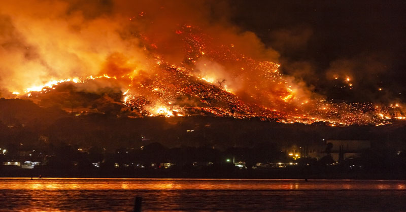 wildfire on hill near lake