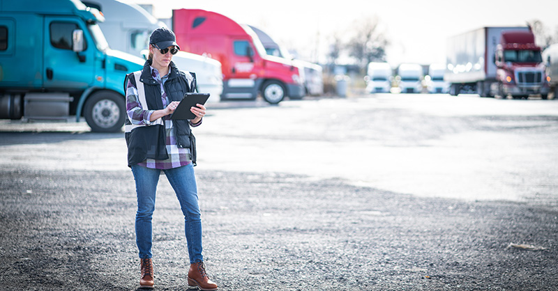 Worker standing in truck yard