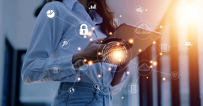 Female professional holding a touch screen device with biometric fingerprint and other icons