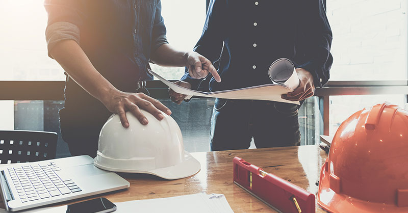 Two males by construction accessories