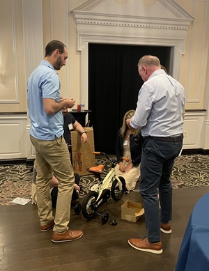 four people building a bike