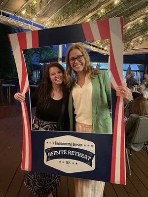 2 women posing for photo with frame prop