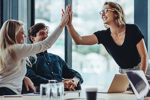 A group of employees high fiving