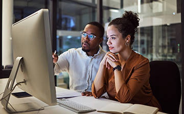Two employees working at a computer