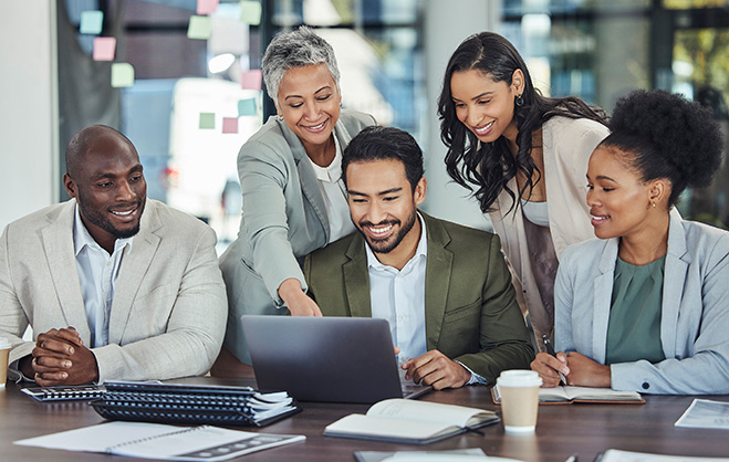 A group of professionals gathered around a computer.