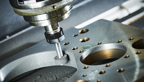 Manufacturing machinery cutting steel alloy