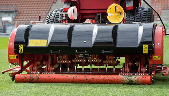 Heavy duty lawn mower on stadium field