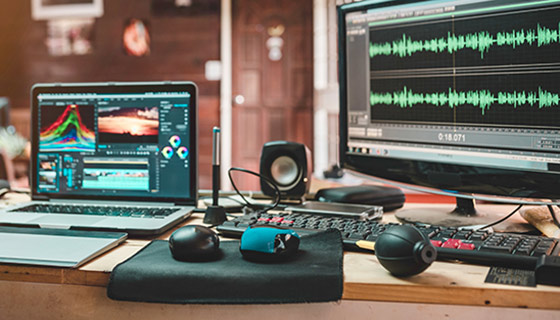 Audio video editing technology including laptop, monitor display, and speakers