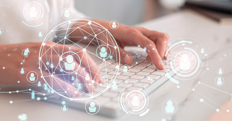 Hands and keyboard with gloabl network graphic overlay